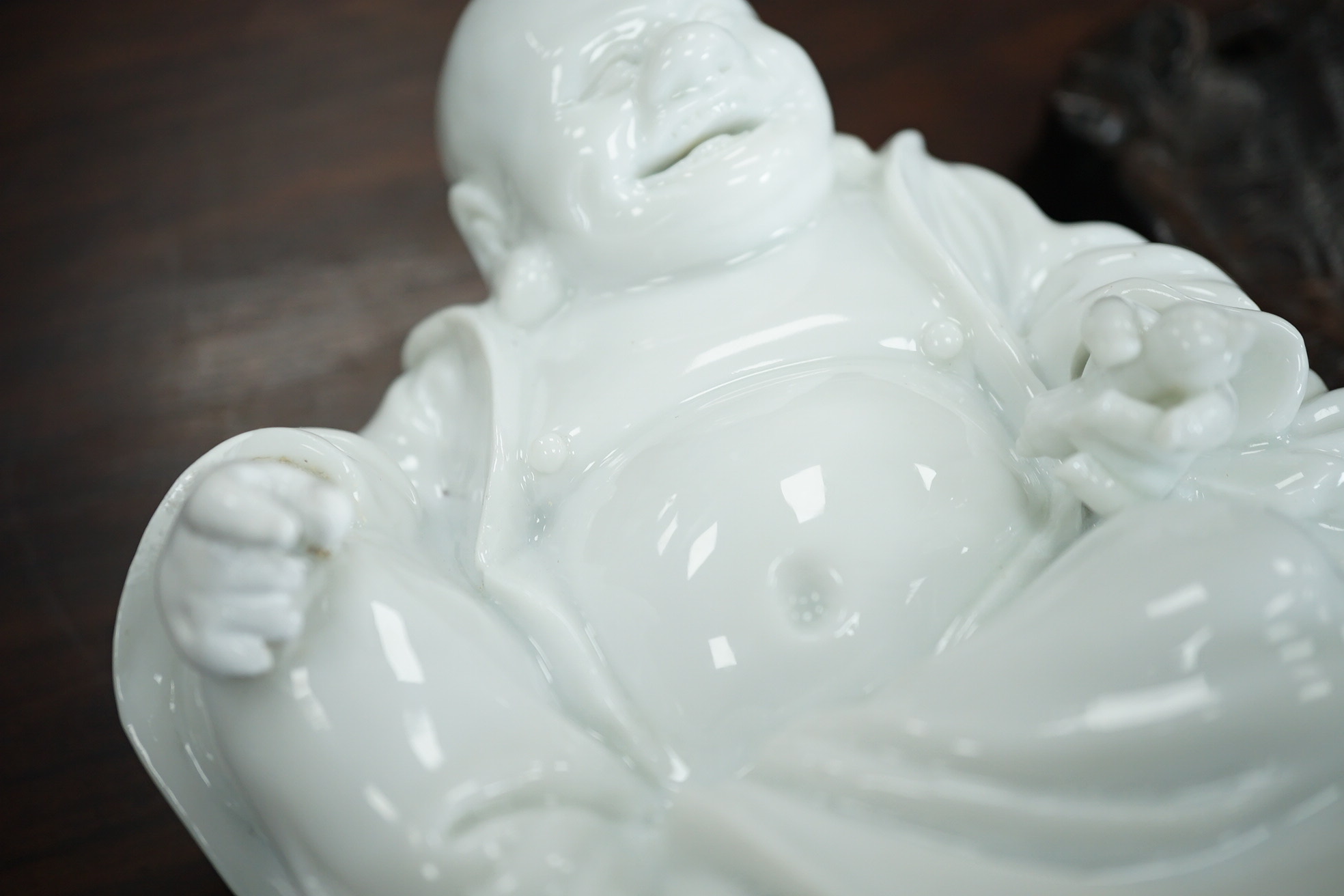 A Chinese blanc-de-chine seated figure of Budai, 18th/19th century